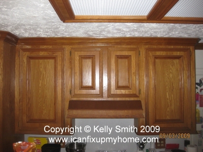Kitchen wall cabinets and exhaust fan installed over electric range