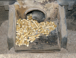A compact pellet stove hopper with auger, photo courtesy Hustvedt
