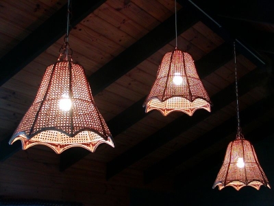 Three pendant lights hanging from living room rafters